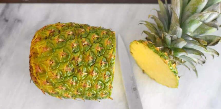 Cut off the top and bottom of the pineapple